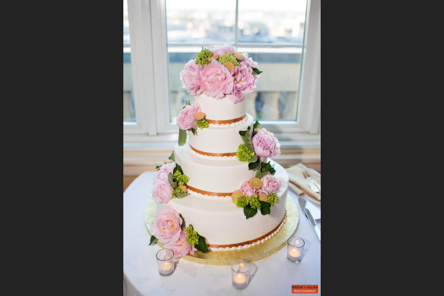 Wedding cake with pink flowers and greenary