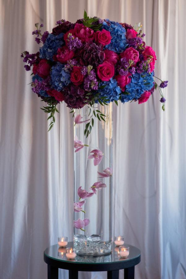 Jewel tone wedding centerpieces by Stapleton Floral Design. Pink, purple, and blue tones. Tall cententerpieces