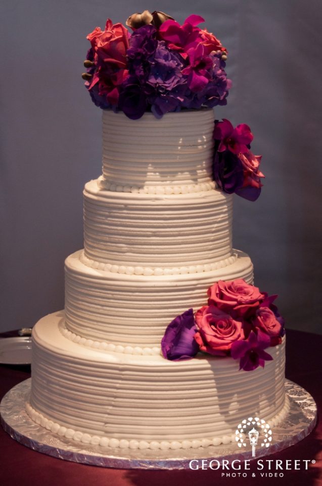 Colorful flowers on wedding cake by Stapleton Floral Design