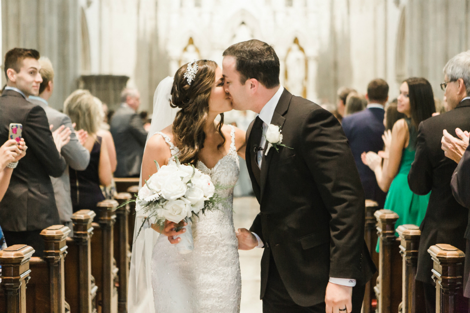 bride and groom kissing at the church