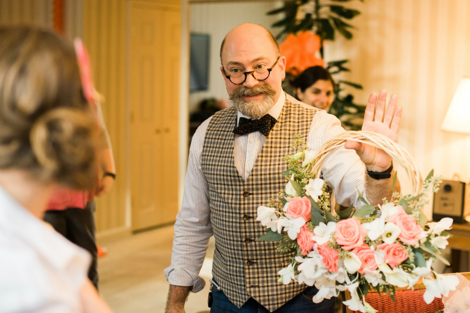 Father of the bride holding a basket of flowers
