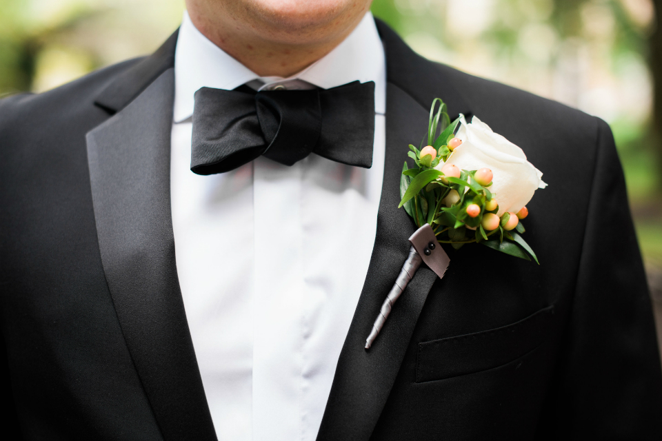 Simple white rose boutonniere with berries