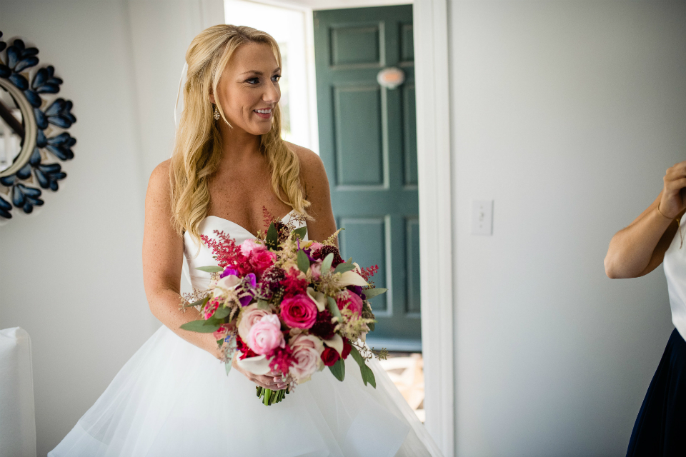 Beautiful bride holding a jewel tone bouquet