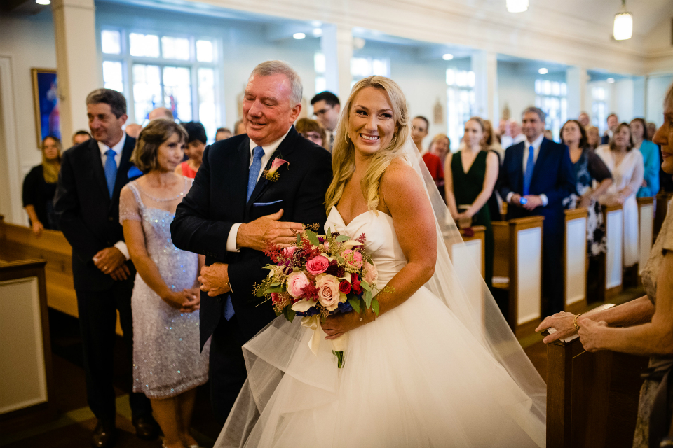 Beautiful bride walking down the aisle with her father