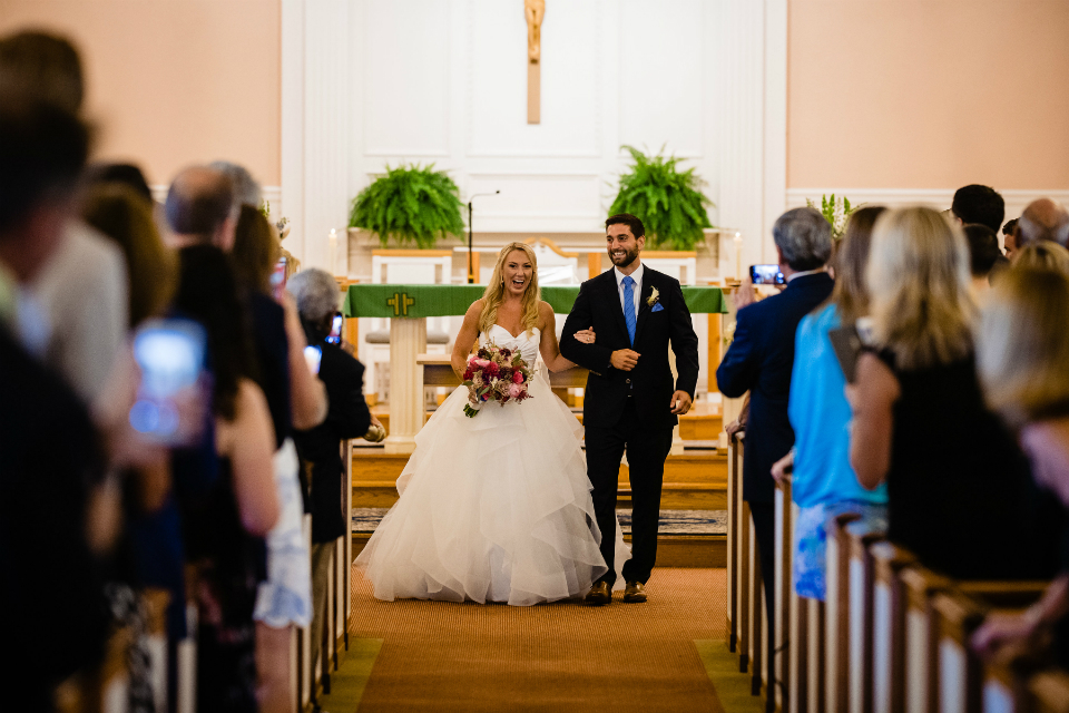 Bride and groom walking down the aisle at the church