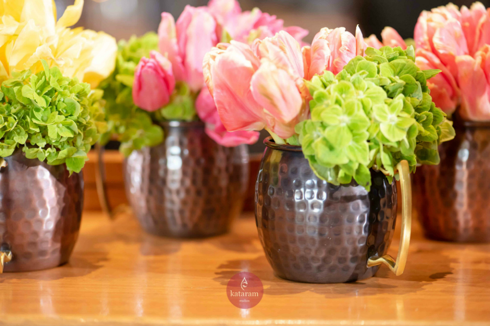 Green hydrangeas and and pink flowers in a mug