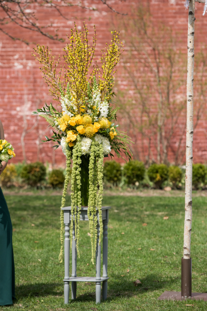Beautiful tall ceremony flowers with yellow roses and cascading greenery by Stapleton Floral Design