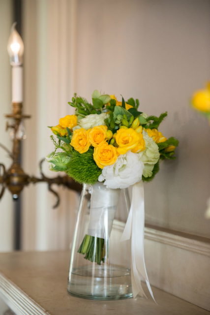 Simple spring bouquet with yellow roses and accents of greenery