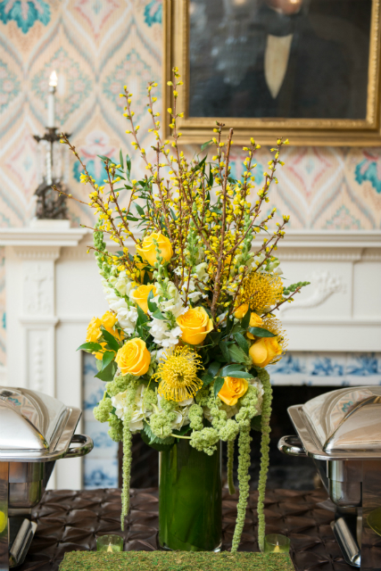 Tall centerpieces spring theme with yellow roses and accents of greenery by Stapleton Floral Design