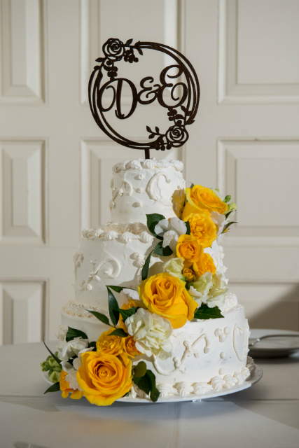Yellow cascading flowers on a wedding cake