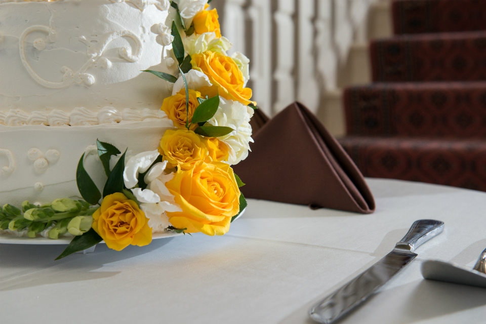 Yellow cascading flowers on a wedding cake