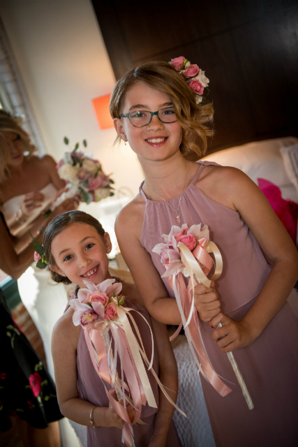 Young bridesmaid with floral wands by Stapleton Floral Design