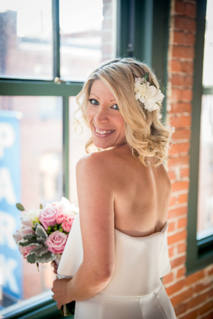 Beautiful bride wearing simple white rose hair piece
