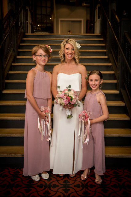 Beautiful bride and her young daughters as bridesmaids