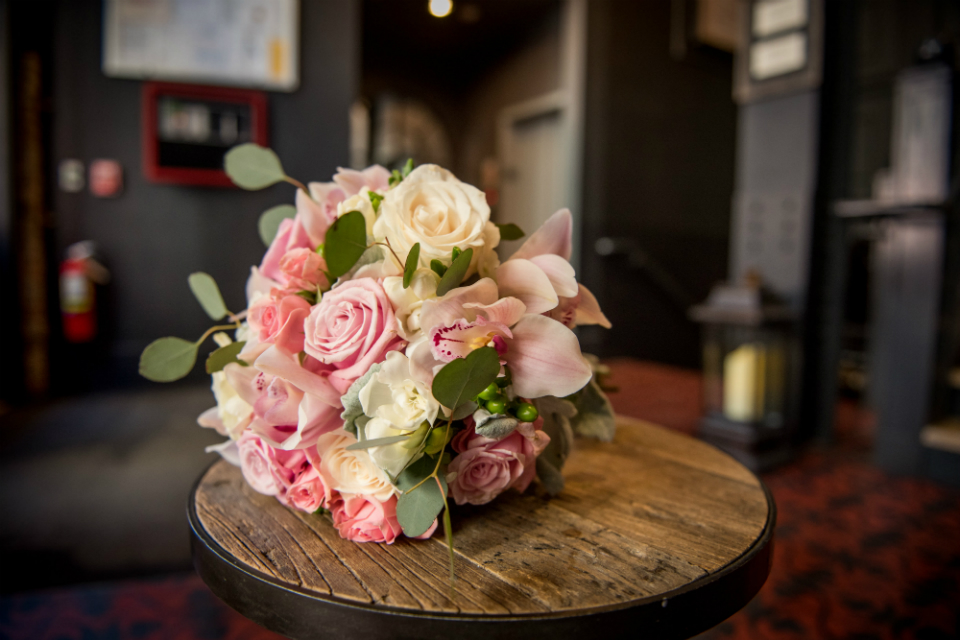 Stunning round bridal bouquet highlighted with touches of white and accented with dusty miller and eucalyptus by Stapleton Floral Design