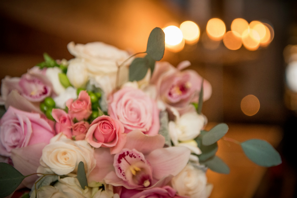 Stunning round bridal bouquet in hues of dusty rose and mauve blossoms highlighted with touches of white and accented with dusty miller and eucalyptus by Stapleton Floral Design