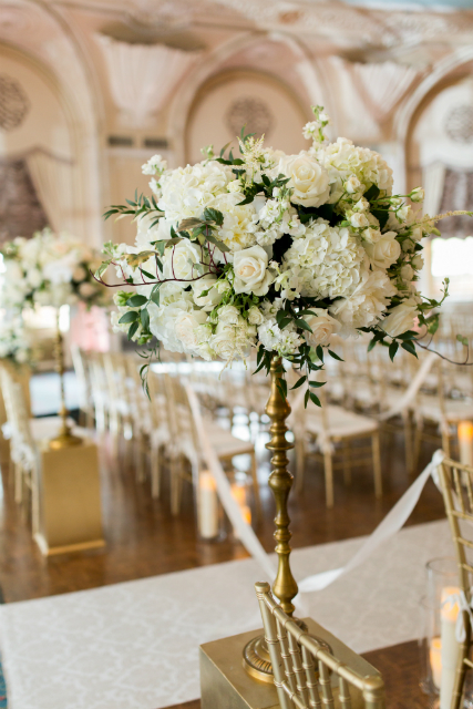 White roses and hydrangeas accented with greenary wedding centerpieces by Stapleton Floral Design