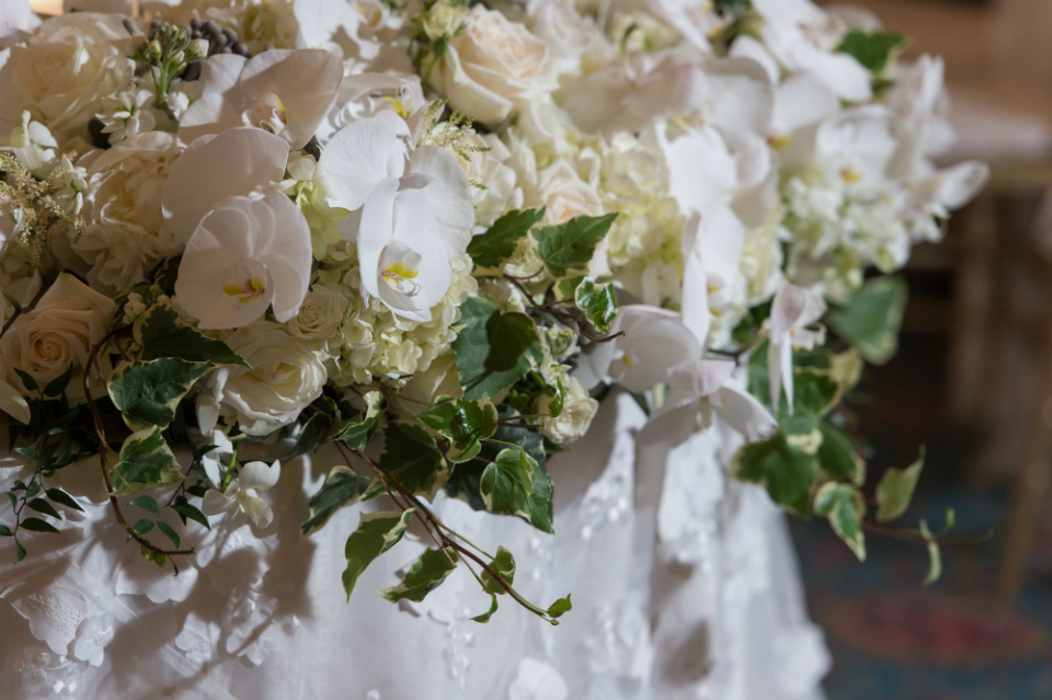 Cream and White floral decor with accents of green for wedding