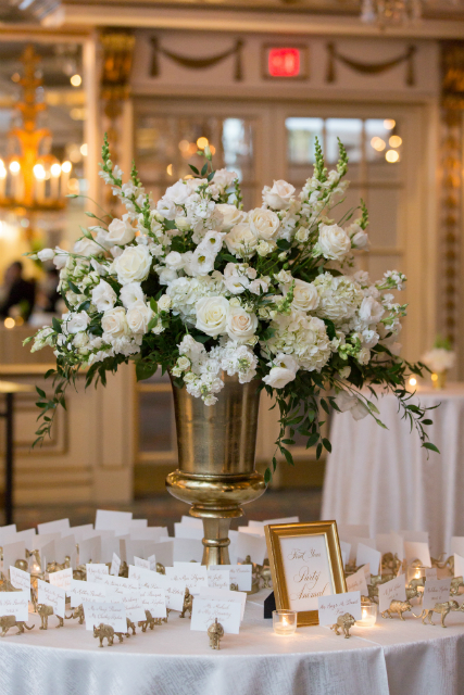 white floral arrangement seating chart table by Stapleton Floral Design