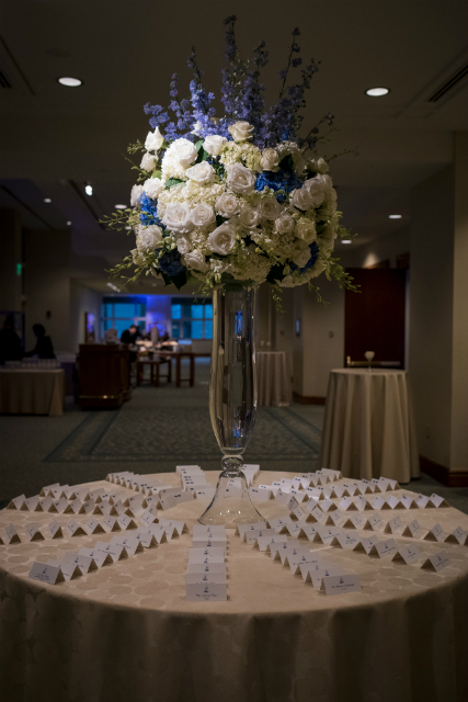 Tall wedding centerpieces with white roses and accents of lavendar