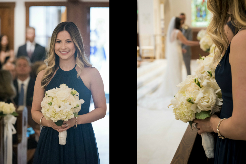 Bridesmaid wearing a nvy dress walking down the aisle with a white bouquet