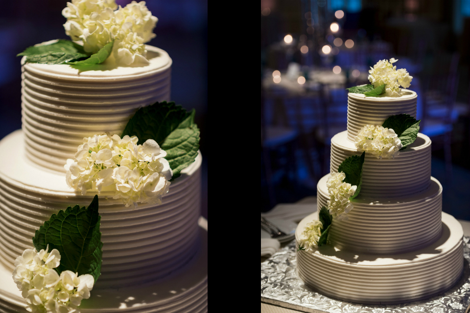 Elegant white wedding cakes with white flowers and accents of green leaves