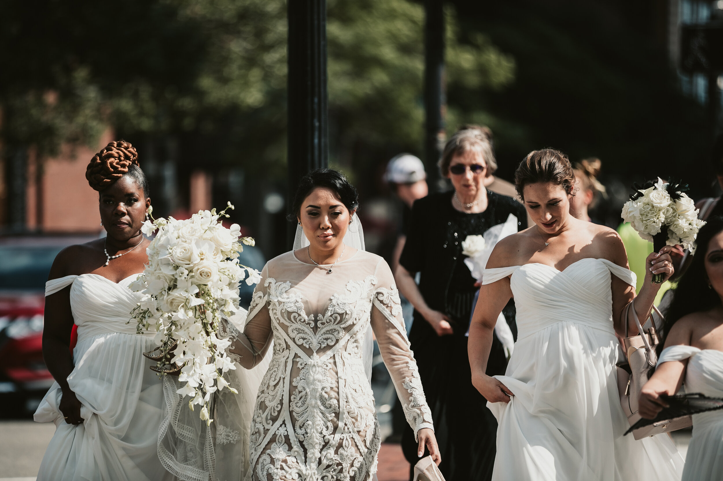 long cascading bridal bouquet composed of all white roses, hawaiin dedrobium orchids, and phalaenopsis orchids