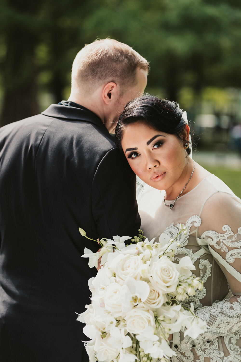 All white roses with green accents bridal bouquet