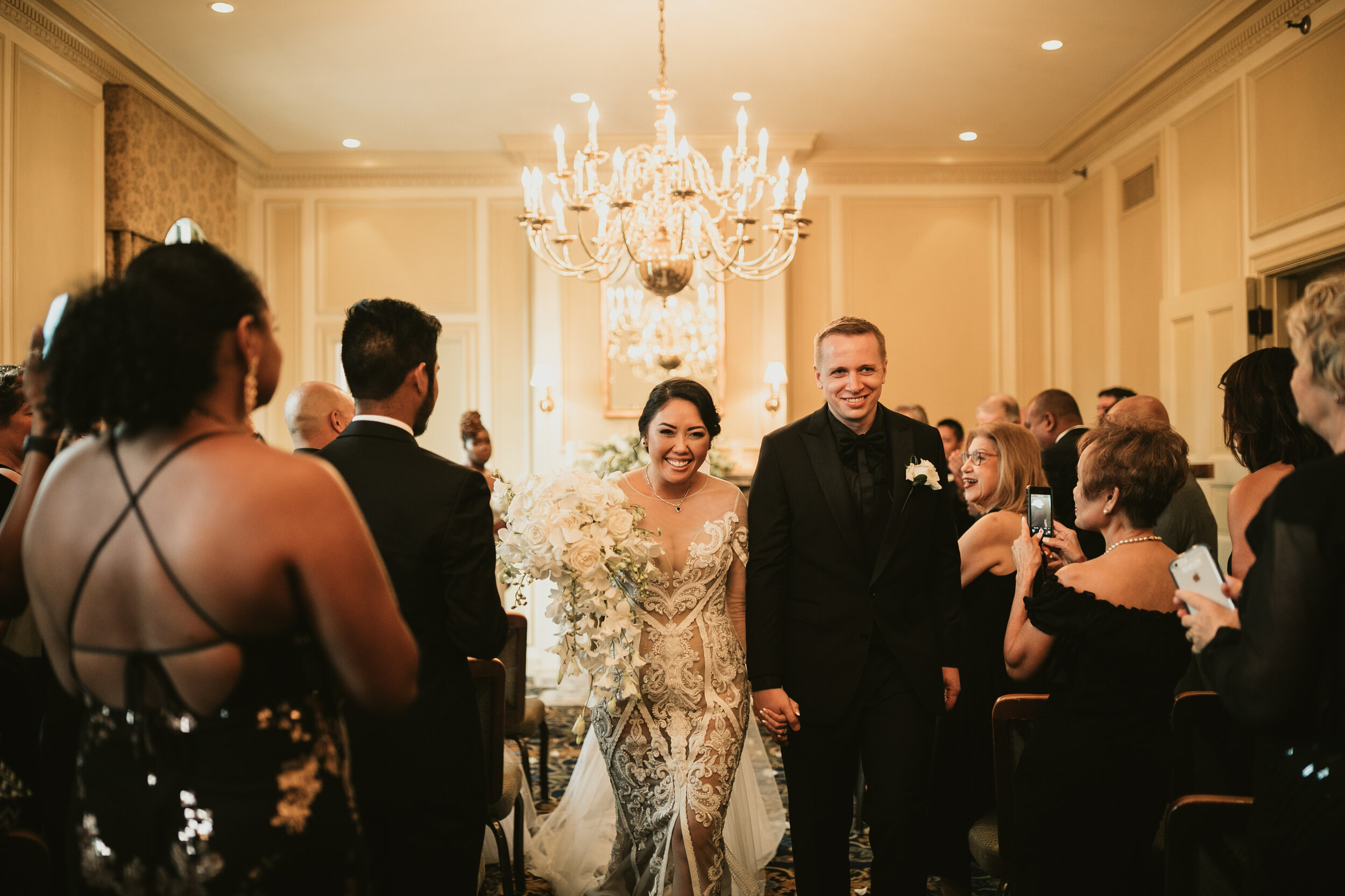 Bride and groom walking down the aisle at Hampshire House