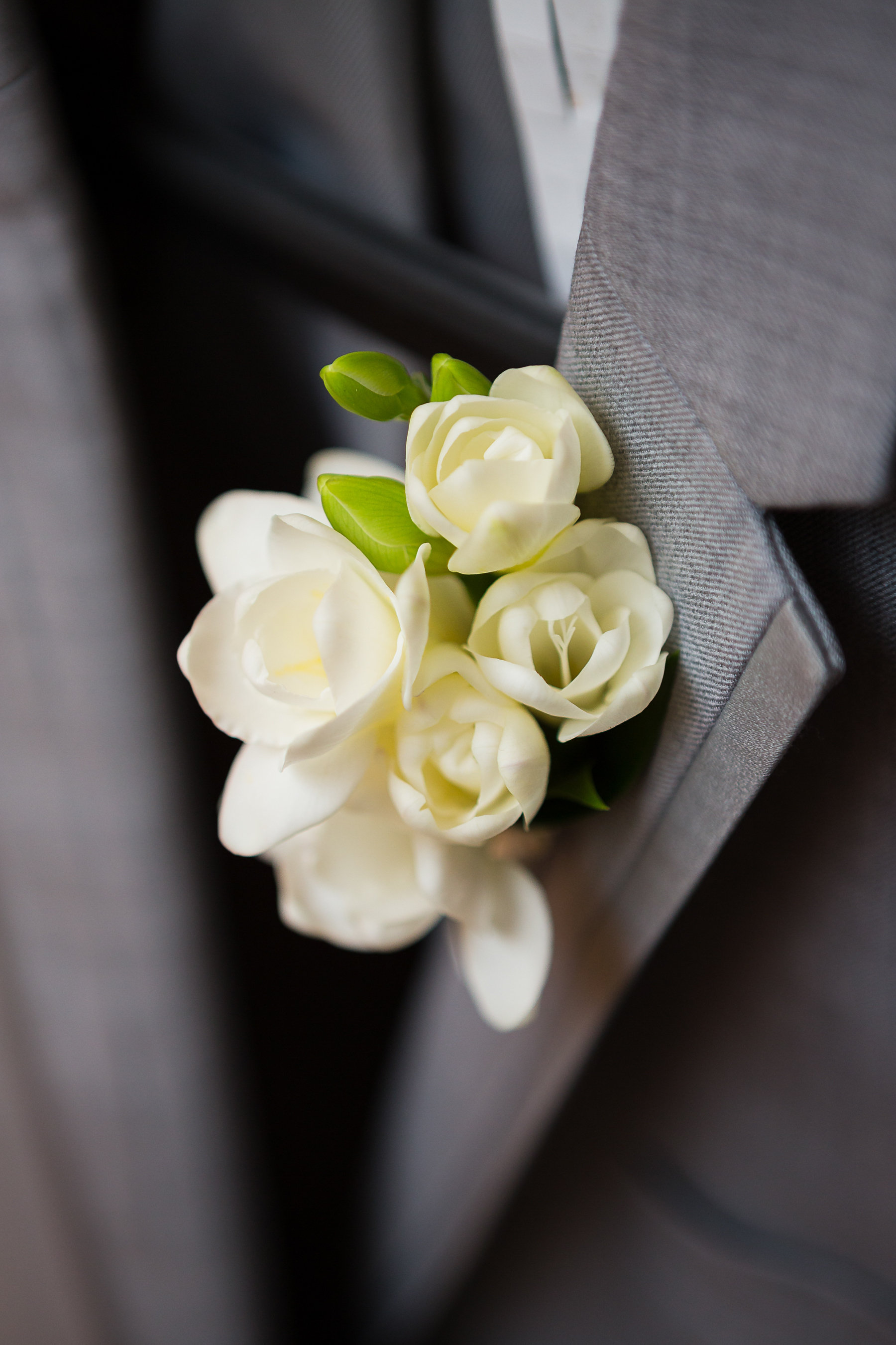 Simple rose boutonniere for the groom