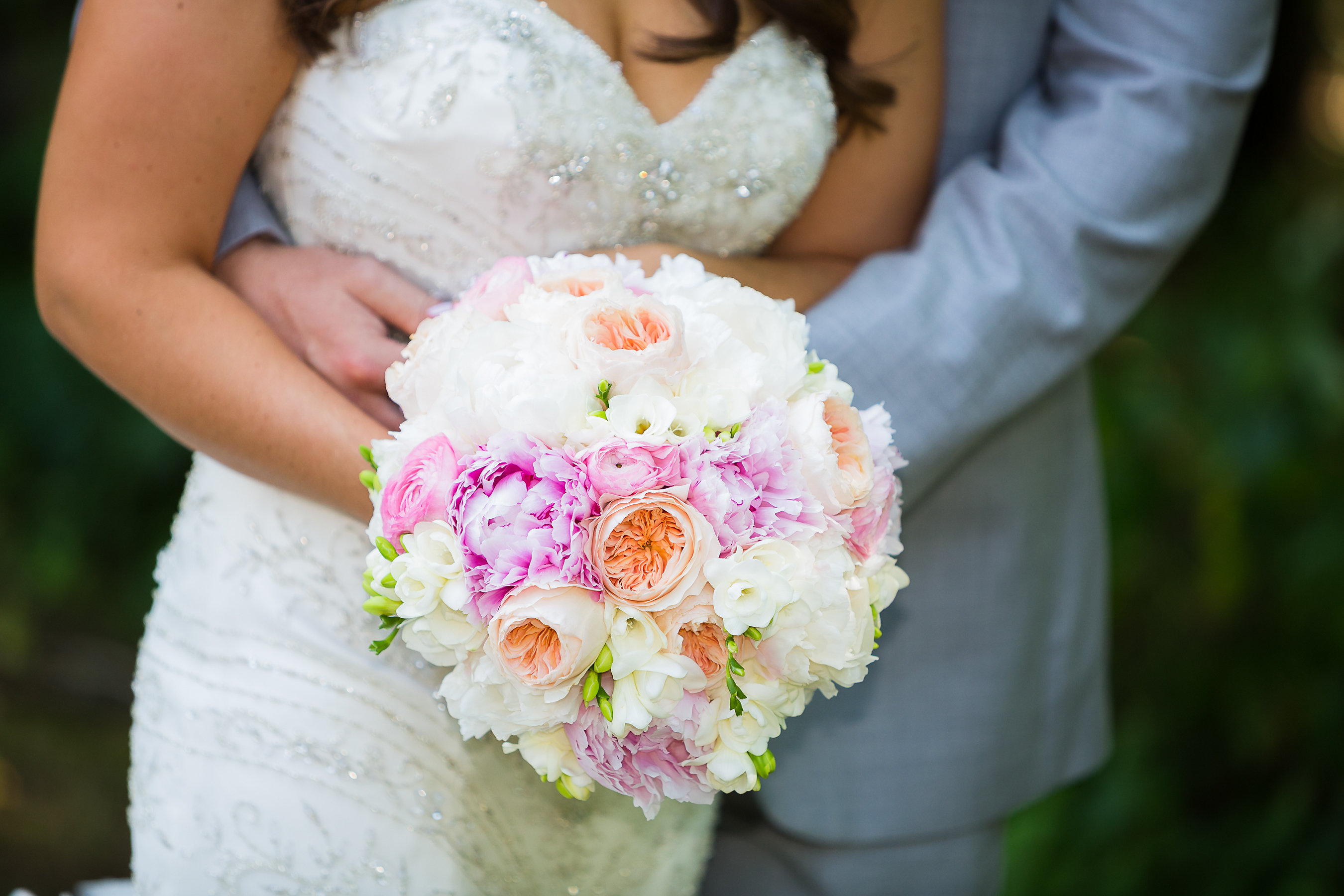 Round bridal bouquet with orange roses and white hydrangeas