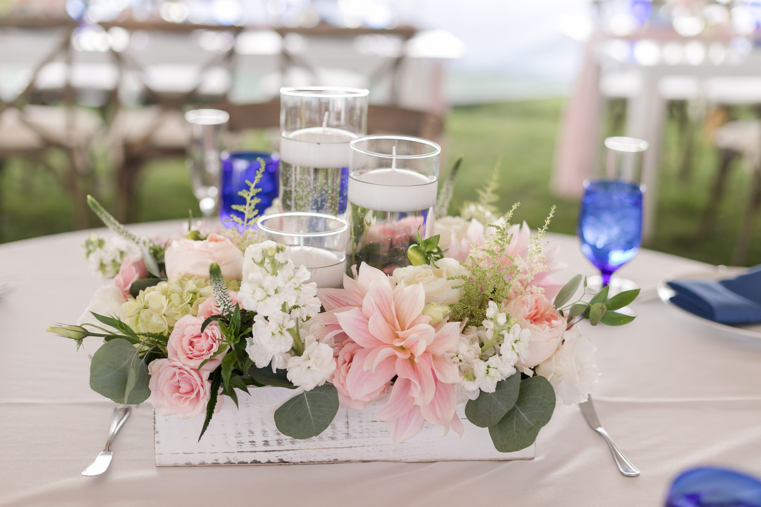 wedding reception table with rustic white wooden box filled with pink and white flowers