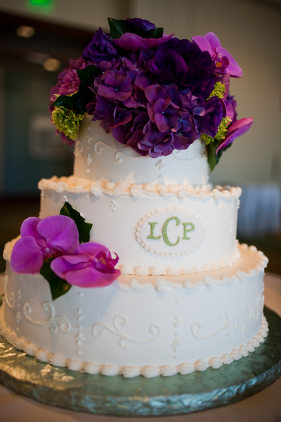 Purple flowers on wedding cake by Stapleton Floral Design