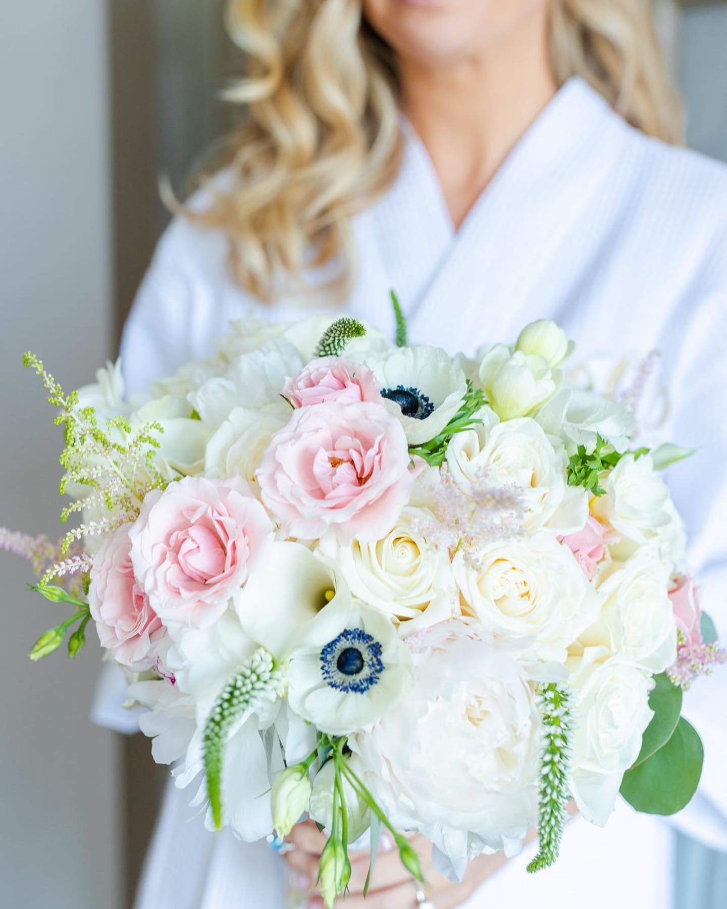 Bride in Robe Holding Floral Bouquet