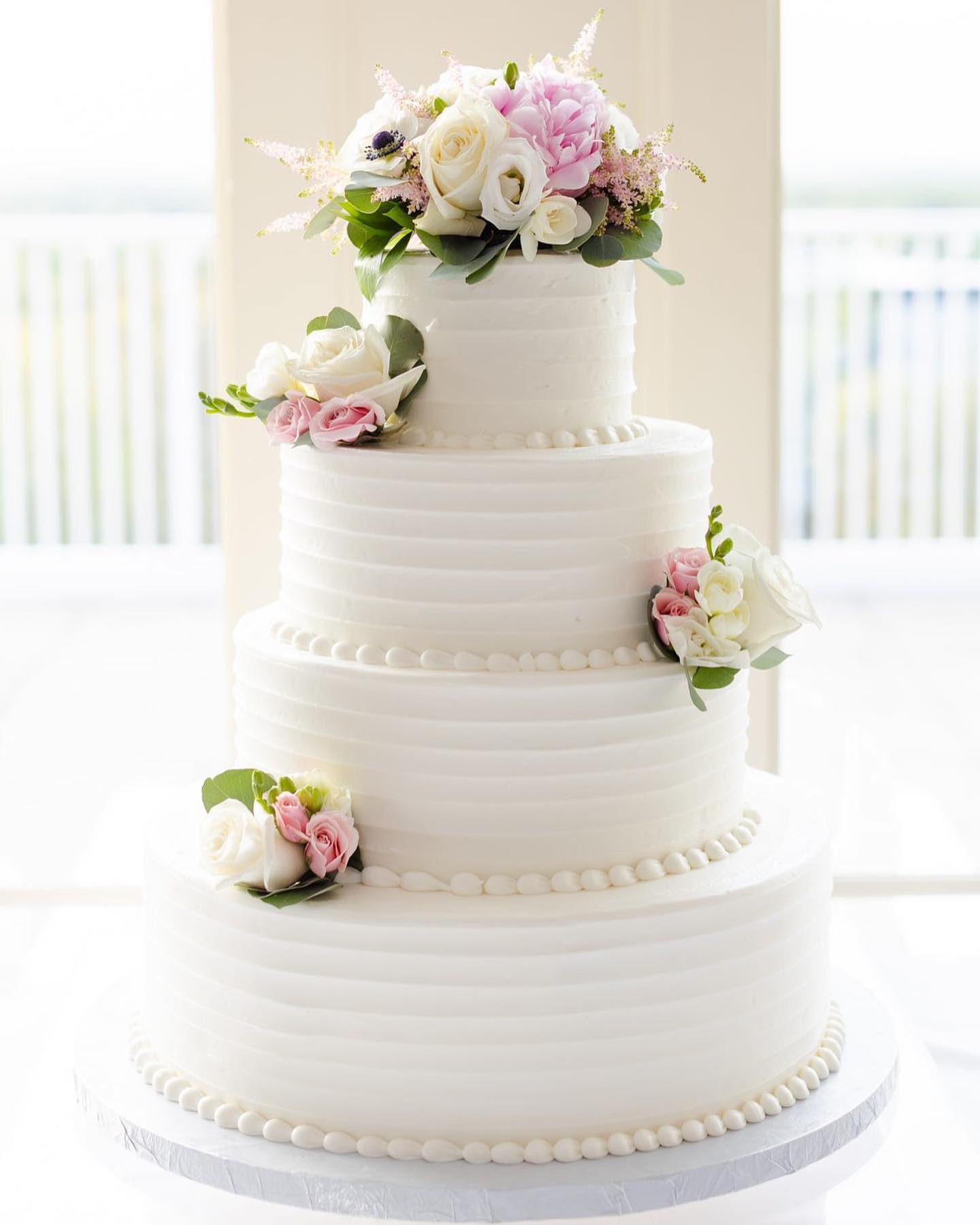 Four Tier Wedding Cake Adorned With Flowers