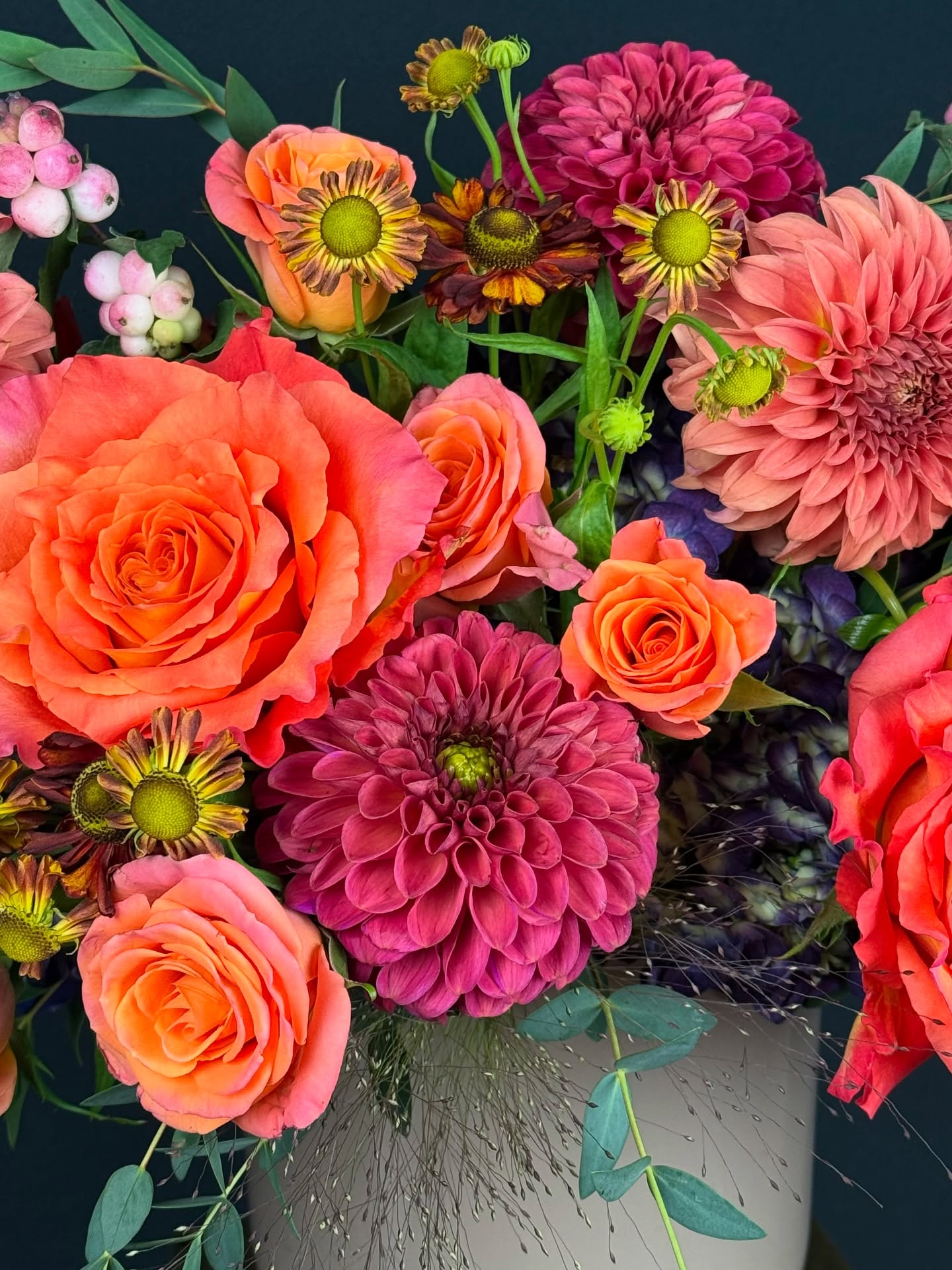 Close-up of the Harborside Harvest floral arrangement with sunset toned dahlias and Free Spirit roses