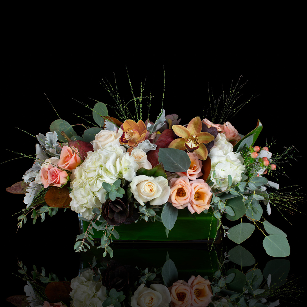 Elegant Thanksgiving floral centerpiece with orchids, roses, hydrangea, and fall textures from Stapleton Floral.
